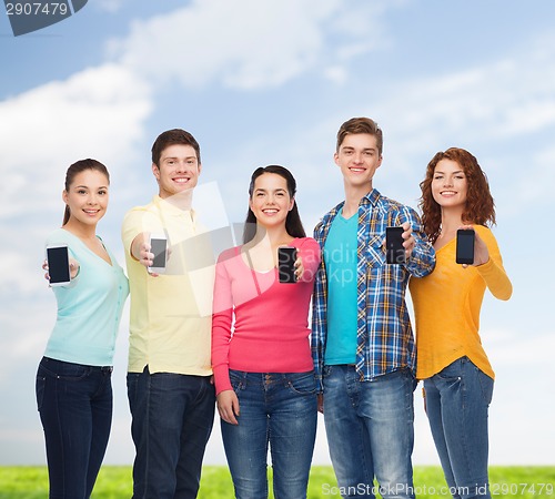 Image of group of smiling teenagers with smartphones