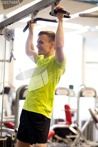 Image of smiling man exercising in gym
