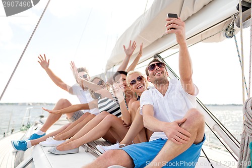 Image of smiling friends sitting on yacht deck