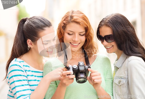 Image of smiling teenage girls with camera
