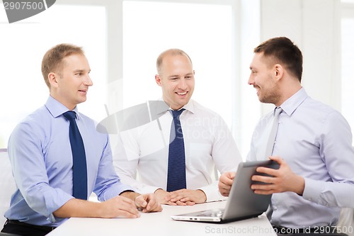 Image of business team working with laptop in office