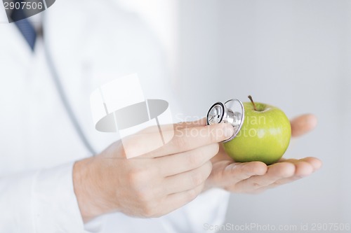 Image of male doctor with green apple and stethoscope