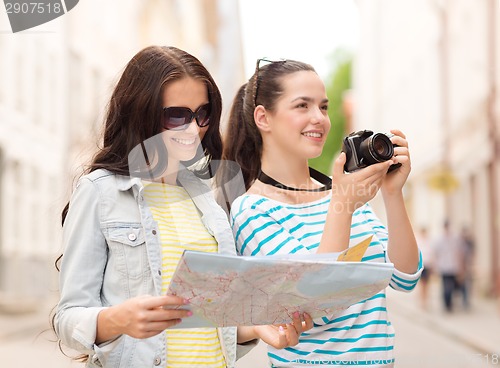 Image of smiling teenage girls with map