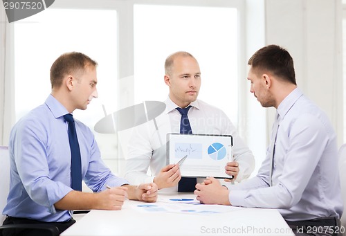 Image of serious businessmen with papers in office