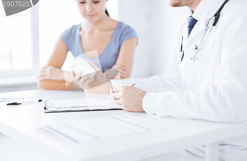 Image of patient and doctor prescribing medication