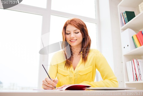 Image of smiling businesswoman or student with tablet pc