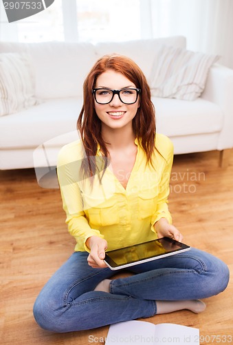 Image of smiling teenage girl with tablet pc at home