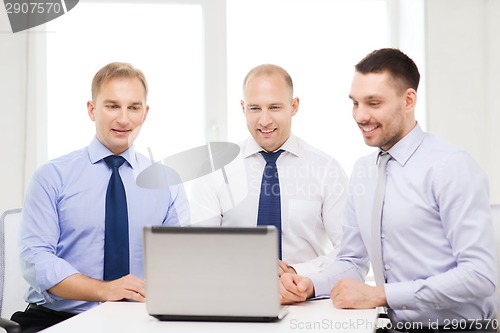 Image of business team working with laptop in office