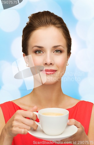 Image of smiling woman in red dress with cup of coffee