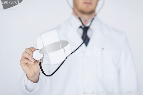 Image of doctor hand with stethoscope listening something