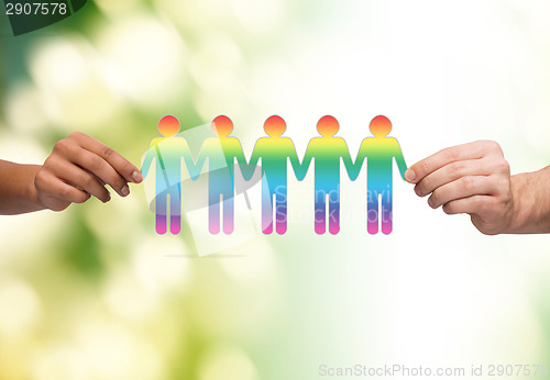 Image of close up of hands holding paper chain gay people