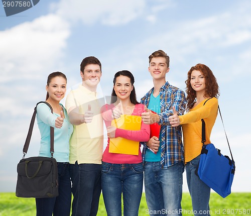 Image of group of smiling teenagers showing thumbs up