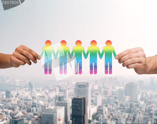 Image of close up of hands holding paper chain gay people