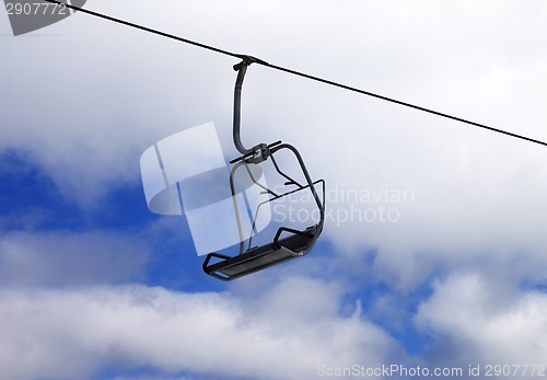 Image of Chair-lift and cloudy sky