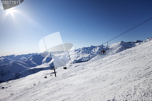 Image of Ski slope and blue sky with sun