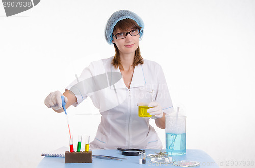 Image of Chemist gaining liquid from a test tube