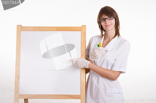 Image of Chemist with test tubes at the board