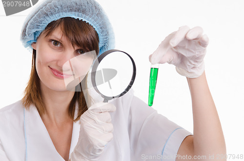 Image of Pharmacist considers the liquid in a test tube