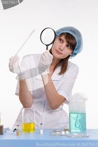 Image of Chemist examines the foam on a stick