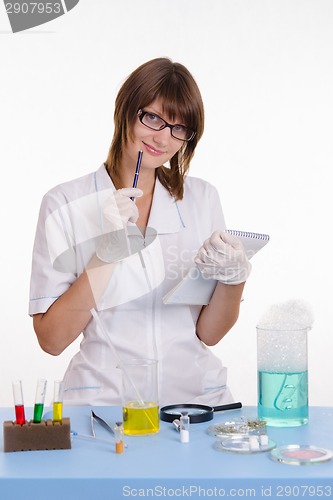 Image of Pharmacist with a notebook in the lab
