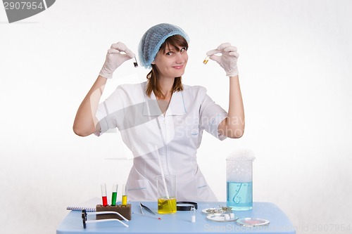 Image of Lab technician with powders in vials