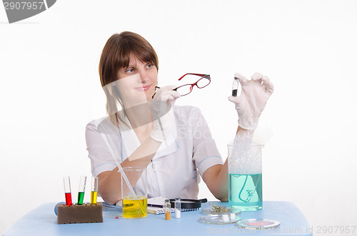 Image of chemist examines powder