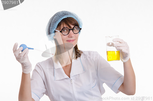 Image of Chemist with a pipette and bulb