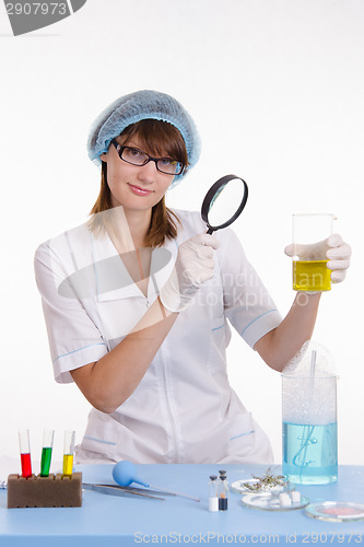 Image of Chemistry teacher looking at liquid in flask