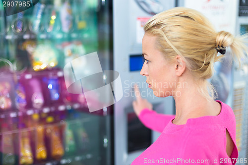 Image of Lady using a modern vending machine