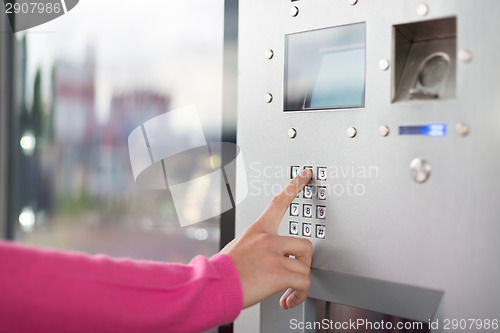 Image of Women's hand using a dial pad.