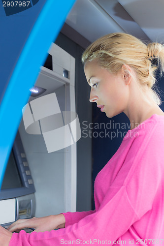 Image of Lady using an atm counter