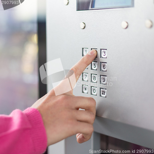 Image of Women's hand using a dial pad