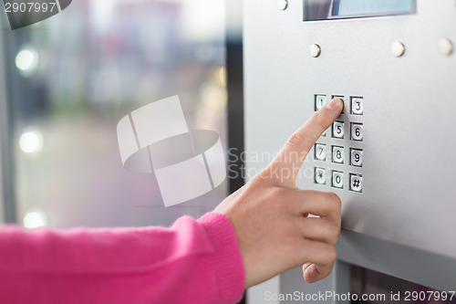 Image of Women's hand using a dial pad