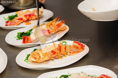 Image of Decorating cooked lobster on plate