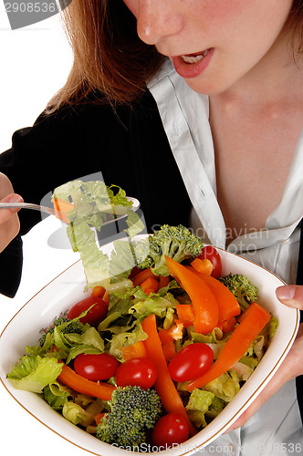Image of Closeup woman eating salad.