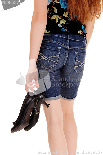 Image of Woman holding her heels.