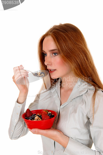 Image of Woman eating breakfast.