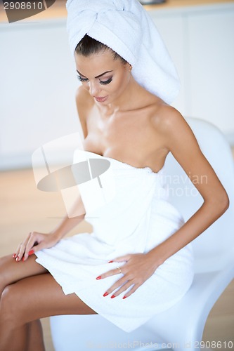 Image of Woman Wearing White Bath Towel Sitting on Chair