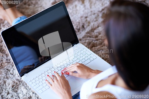 Image of Hands of a woman typing on a laptop computer