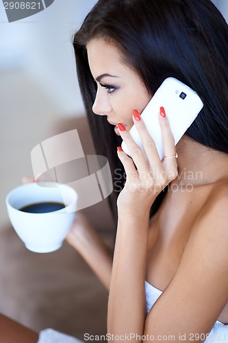 Image of Young woman listening to a mobile phone call