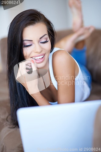 Image of Beautiful woman smiling in amusement