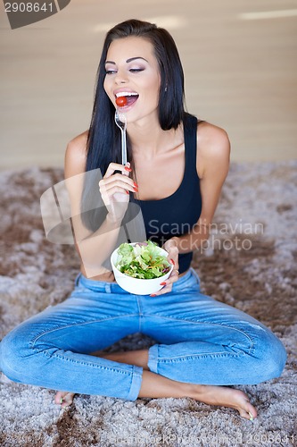 Image of Healthy young woman enjoying a fresh salad