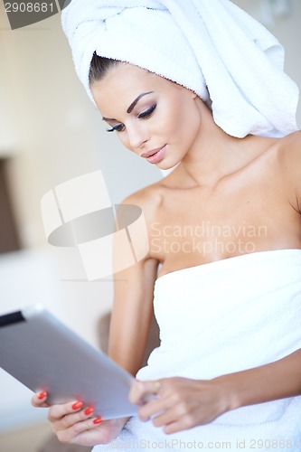 Image of Woman wrapped in clean white towels