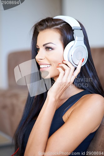 Image of Beautiful young woman listening to music