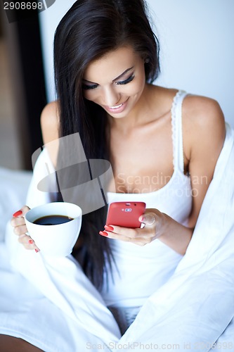 Image of Young woman texting on her mobile phone