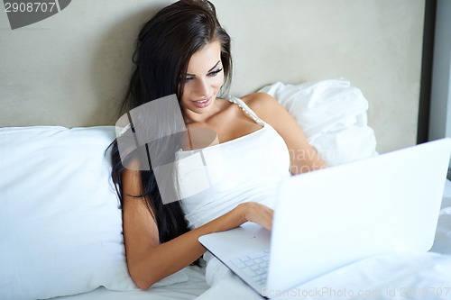 Image of Smiling woman catching up on her social media