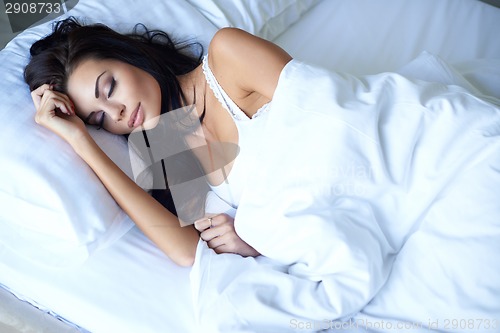 Image of Beautiful young woman sleeping peacefully in bed