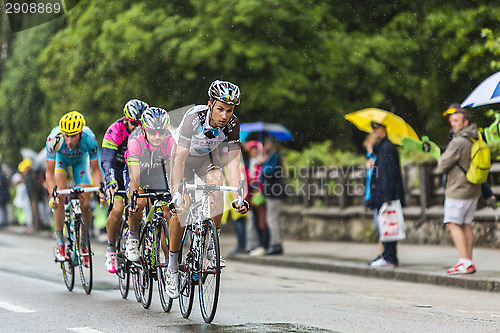 Image of Group of Cyclists Riding in the Rain