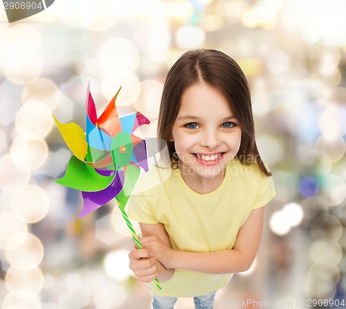 Image of smiling child with colorful windmill toy