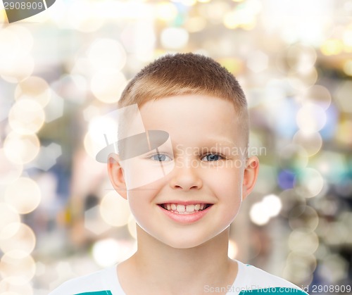 Image of smiling little boy over sparkling background